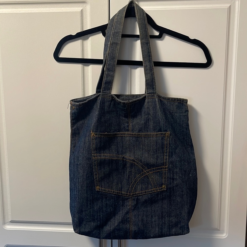 Denim tote with pants style pocket on the front